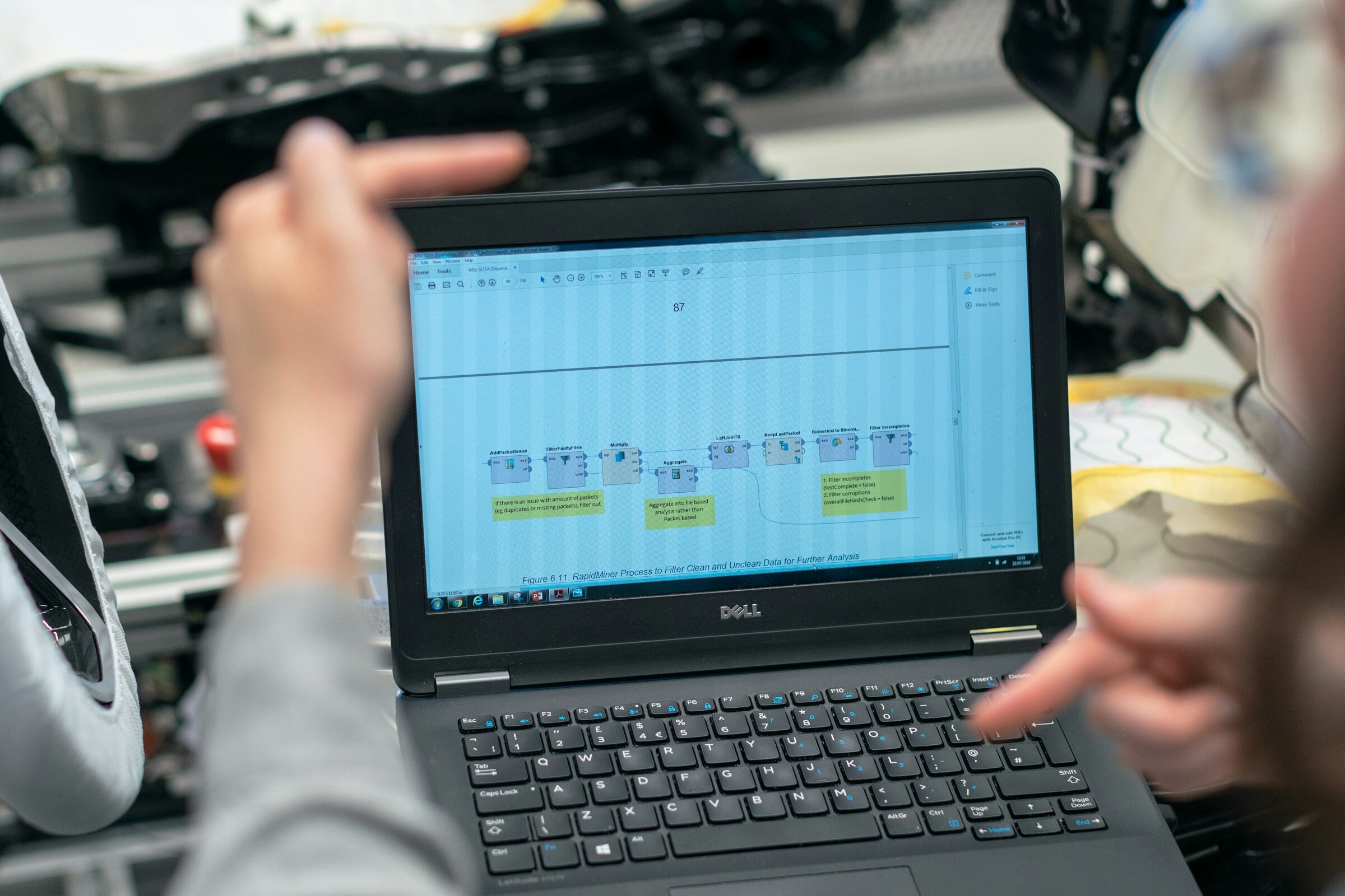 Engineers reviewing a data process beside industrial equipment