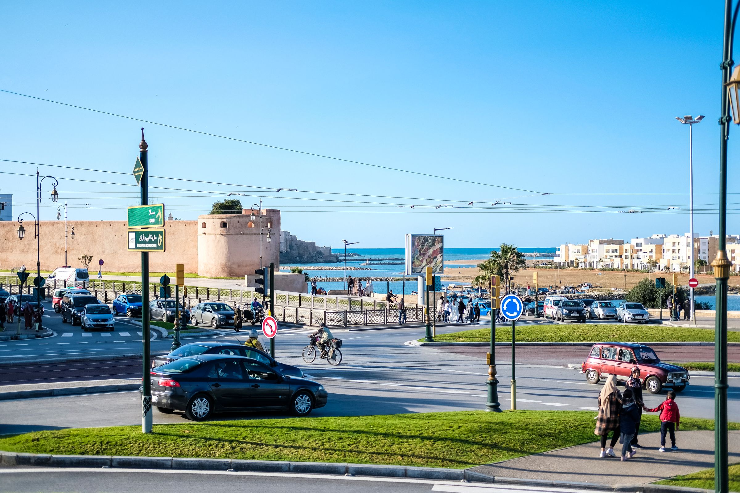 People moving through an urban intersection and public space in Rabat